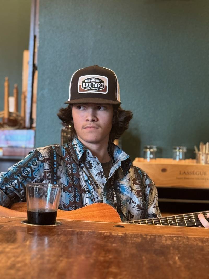 Matteo in a Red Dirt cap and western shirt